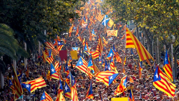 People hold  Catalan separatist flags known as "Esteladas" during a gathering to mark the Calatalonia day "Diada" in central Barcelona